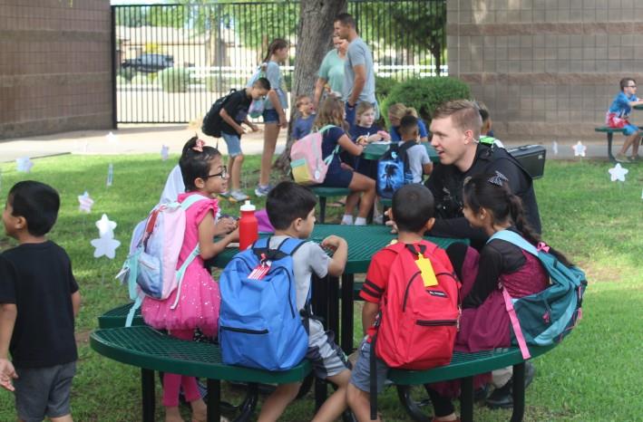 Officer hanging out with students